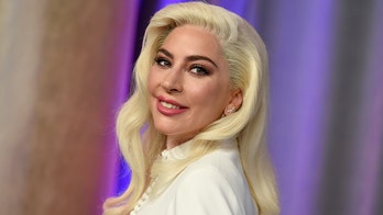 Lady Gaga has been 'communicating' with dog walker as she remains in Italy following shooting, her dad says