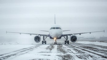 Aircraft slides off snowy runway, across field and into highway