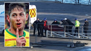 Team working on soccer star Emiliano Sala's plane crash carry body onshore after pulling it from wreckage