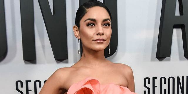 Vanessa Hudgens stunned in a low-cut black swimsuit on Tuesday while standing in the snow.