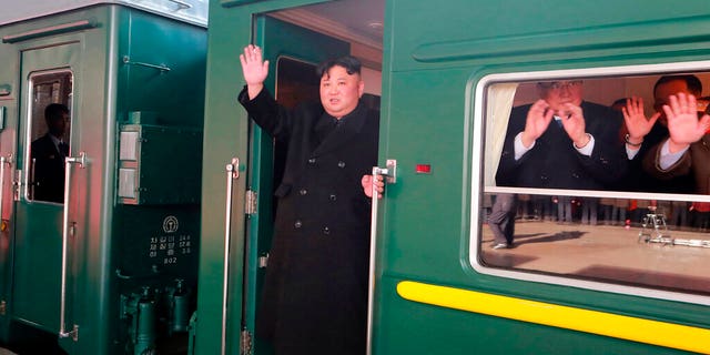 In this Saturday, Feb. 23, 2019, photo provided on Sunday, Feb. 24, 2019, by the North Korean government, North Korean leader Kim Jong Un waves from a train before leaving Pyongyang Station, North Korea, for Vietnam. 