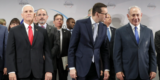 United States Vice President Mike Pence, Prime Minister of Poland Mateusz Morawiecki and Israeli Prime Minister Benjamin Netanyahu, from left, stand on a podium at a conference on Peace and Security in the Middle East in Warsaw, Poland, Thursday, Feb. 14, 2019. The Polish capital is host for a two-day international conference, co-organized by Poland and the United States. (AP Photo/Michael Sohn)
