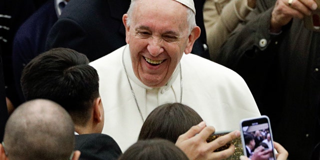Pope Francis smiles as he arrives in the Paul VI hall on the occasion of his weekly general audience at the Vatican, Wednesday, Feb. 6, 2019. (AP Photo/Gregorio Borgia)
