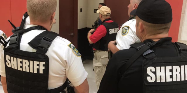 Sheriff's deputies search Farnell Middle School after a student falsely claimed to see a man with a gun on campus.