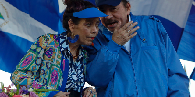 FILE - In this Sept. 5, 2018 file photo, the President of Nicaragua Daniel Ortega and his wife and Vice-President Rosario Murillo preside a rally in Managua, Nicaragua. President Ortega said Thursday, Feb. 21, 2019, that he will restart talks with his opponents, seven months after the last round of dialogue broke down and the government unleashed a round of arrests. (AP Photo/Alfredo Zuniga, File)