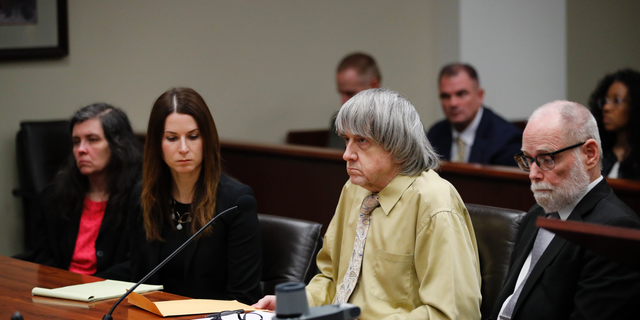 David Turpin, second from right, and wife, Louise, far left, sit in a courtroom with their attorneys, Allison Lowe, second from left, and David Macher Friday, Feb. 22, 2019, in Riverside, Calif. The California couple who shackled some of their 13 children to beds and starved them have pleaded guilty to torture and other abuse. (AP Photo/Jae C. Hong, Pool)
