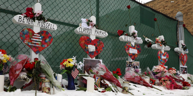 A memorial displaying 58 crosses by Greg Zanis stands at the Welcome To Las Vegas Sign Thursday, Oct. 5, 2017, in Las Vegas. (Mikayla Whitmore/Las Vegas Sun via AP)