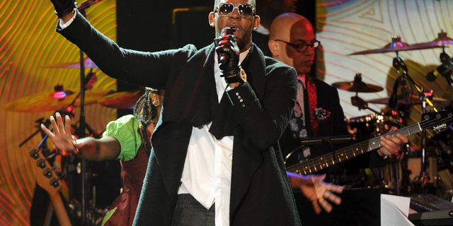 FILE - In this Jan. 25, 2014 file photo, recording artist R. Kelly performs at The 56th Annual Grammy Awards Salute to Industry Icons with Clive Davis in Beverly Hills, Calif. R. Kelly, the R&B star who has been trailed for decades by allegations that he violated underage girls and women and held some as virtual slaves, was charged Friday, Feb. 22, 2019, with aggravated sexual abuse involving four victims, including at least three between the ages of 13 and 17. (Photo by Frank Micelotta/Invision/AP, File)
