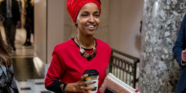 In this Jan. 16, 2019 file photo, Rep. Ilhan Omar, D-Minn., center, walks through the halls of the Capitol Building in Washington. (AP Photo/Andrew Harnik)