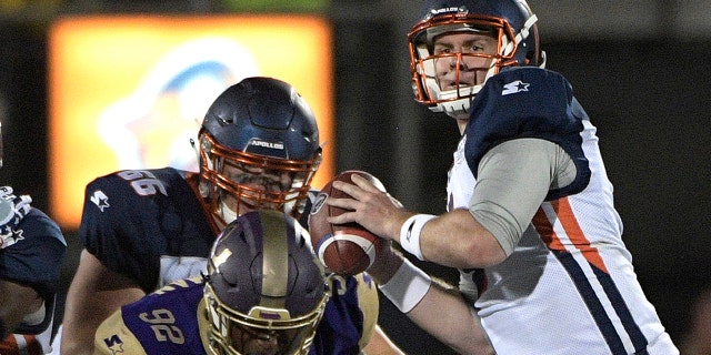 Orlando Apollos quarterback Garrett Gilbert, right, sets up to throw a pass in front of Atlanta Legends linebacker KeShun Freeman (92) during the first half of an Alliance of American Football game Saturday, Feb. 9, 2019, in Orlando, Fla. (Associated Press)