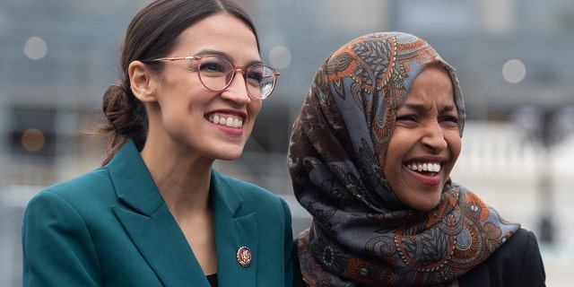 US Representative Alexandria Ocasio-Cortez, Democrat of New York, and US Representative Ilhan Omar (R), Democrat of Minnesota, attend a press conference calling on Congress to cut funding for US Immigration and Customs Enforcement (ICE) and to defund border detention facilities, outside the US Capitol in Washington, DC, February 7, 2019. (Photo by SAUL LOEB / AFP) (Photo credit should read SAUL LOEB/AFP/Getty Images)