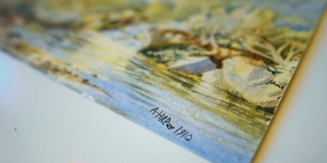 In this Thursday, Jan. 24, 2019 picture a watercolor landscape is displayed at an auction house in Berlin, Germany. Berlin police say three watercolor landscapes allegedly painted by a young Adolf Hitler are being examined by experts to determine if they are fakes. The paintings were seized from a city auction house before they could be sold after they had received a complaint questioning their authenticity. (Gregor Fischer/dpa via AP)
