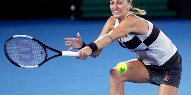 Petra Kvitova of the Czech Republic makes a backhand return to Japan's Naomi Osaka during the women's singles final at the Australian Open tennis championships in Melbourne, Australia, Saturday, Jan. 26.