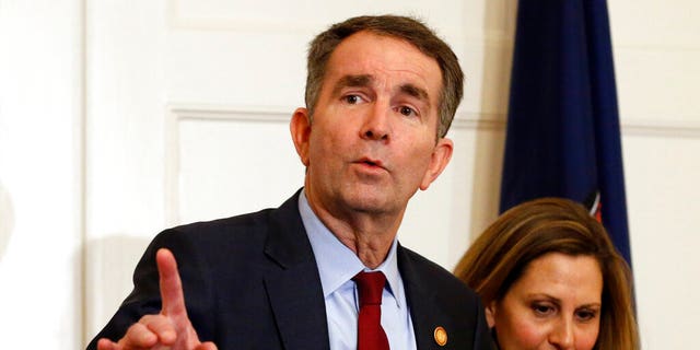 Virginia Gov. Ralph Northam, left, gestures as his wife, Pam, listens during a news conference in the Governors Mansion at the Capitol in Richmond, Va., Saturday, Feb. 2, 2019. Northam is under fire for a racial photo the appeared in his college yearbook. (AP Photo/Steve Helber)