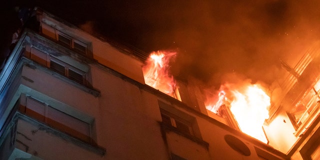 In this image provided on Tuesday, Feb. 5, 2019 by the Brigade de Sapeurs-Pompiers de Paris (Paris Fire Brigade) a fire rages through the top floors of an apartment building in Paris, France.