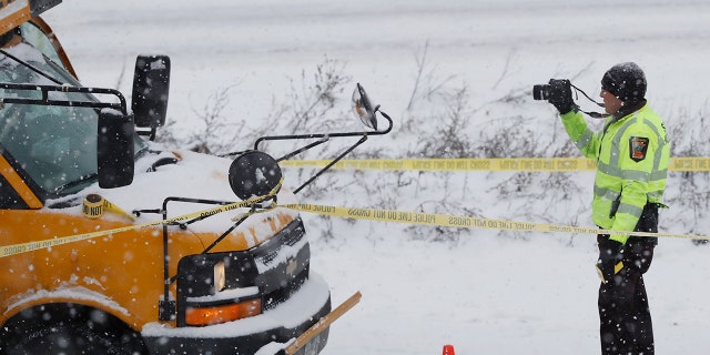 The driver of a school bus was taken to the hospital in a shooting on HWY 35 near downtown Minneapolis, Tuesday, Feb. 5, 2019. Authorities say a school bus driver was wounded in a shooting that followed a crash with another vehicle on a snowy interstate near downtown Minneapolis. (Richard Tsong-Taatarii/Star Tribune via AP)