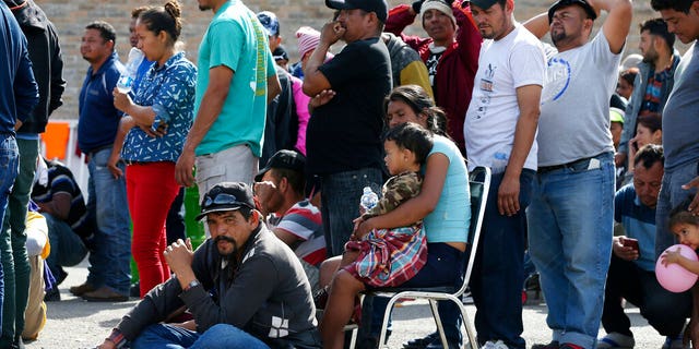 Immigrants from Central America are lining up to register with Mexican immigration authorities in a shelter in Piedras Negras, Mexico, on Tuesday, February 5, 2019. A caravan of about 1,600 Central American migrants camped Tuesday in the Mexican border town of Piedras Negras, just in Eagle Pass, Texas. The governor of Coahuila State in the north of the country described the migrants as "asylum seekers", suggesting that all had the express intention of surrendering to US authorities. (Jerry Lara / The San Antonio Express-News via AP)