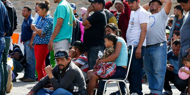 Immigrants from Central America are lining up to register with Mexican immigration authorities in a shelter in Piedras Negras, Mexico, on Tuesday, February 5, 2019. A caravan of about 1,600 Central American migrants camped Tuesday in the Mexican border town of Piedras Negras, just in Eagle Pass, Texas. The governor of Coahuila State in the north of the country described the migrants as "asylum seekers", suggesting that all had the express intention of surrendering to US authorities. (Jerry Lara / The San Antonio Express-News via AP)