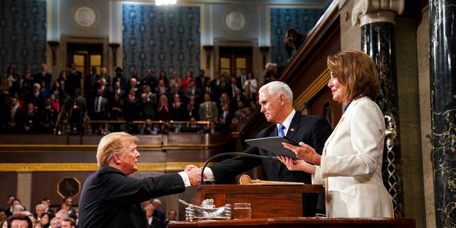 President Donald Trump shakes hands with Vice President Mike Pence, as House Speaker Nancy Pelosi looks on, as he arrives in the House chamber before giving his State of the Union address to a joint session of Congress, Tuesday, Feb. 5, 2019 at the Capitol in Washington. (Doug Mills/The New York Times via AP, Pool)