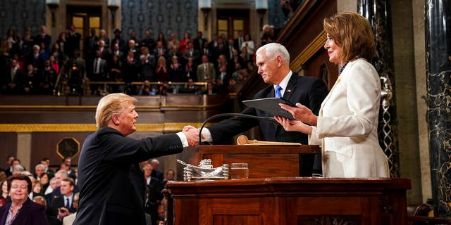 President Donald Trump shakes hands with Vice President Mike Pence, as House Speaker Nancy Pelosi looks on, as he arrives in the House chamber before giving his State of the Union address to a joint session of Congress, Tuesday, Feb. 5, 2019 at the Capitol in Washington. (Doug Mills/The New York Times via AP, Pool)