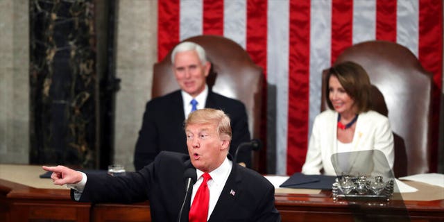 President Donald Trump acknowledges women in Congress as he delivers his State of the Union address to a joint session of Congress on Capitol Hill in Washington, as Vice President Mike Pence and Speaker of the House Nancy Pelosi, D-Calif., watch, Tuesday, Feb. 5, 2019. (AP Photo/Andrew Harnik)