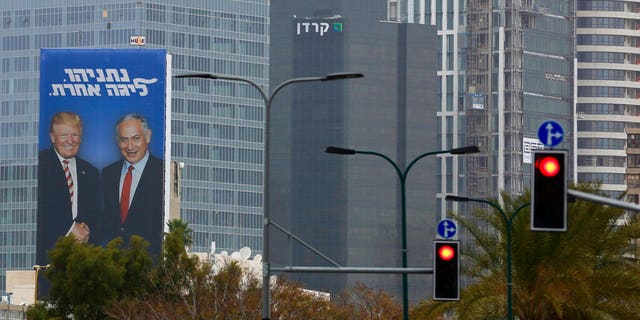 In this Wednesday, Feb. 6, 2019 photo, an election campaign billboard shows Israeli Prime Minister Benjamin Netanyahu, and US President Donald Trump in Tel Aviv, Israel.