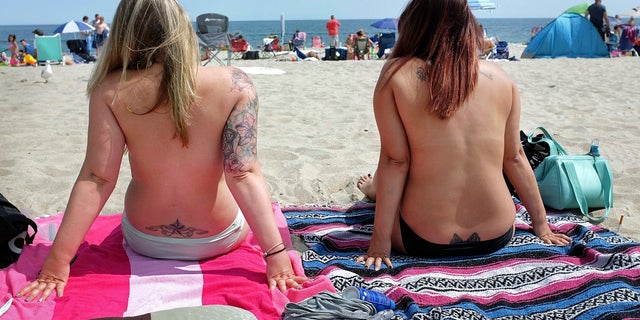 Women go topless as they participate in the Free the Nipple global movement during Go Topless Day at Hampton Beach, N.H., Aug. 26, 2017. (Ioanna Raptis/Portsmouth Herald seacoastonline.com via AP)