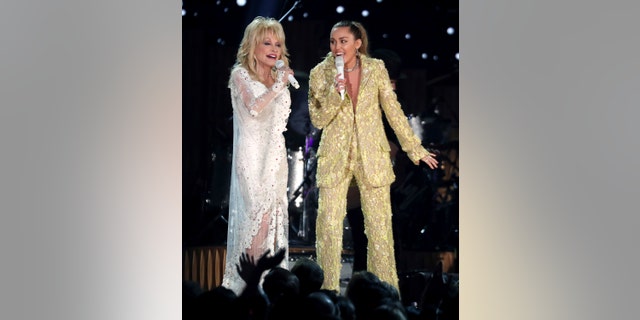 Dolly Parton, left, and Miley Cyrus perform "Jolene" at the 61st annual Grammy Awards on Sunday, Feb. 10, 2019, in Los Angeles.