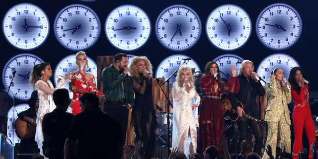 Maren Morris, from left, Katy Perry, Jimi Westbrook, Kimberly Schlapman, Dolly Parton, Karen Fairchild, Philip Sweet, Miley Cyrus and Kacey Musgraves perform "9 to 5" at the 61st annual Grammy Awards on Sunday, Feb. 10, 2019, in Los Angeles.