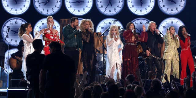 Maren Morris, from left, Katy Perry, Jimi Westbrook, Kimberly Schlapman, Dolly Parton, Karen Fairchild, Philip Sweet, Miley Cyrus and Kacey Musgraves perform "9 to 5" at the 61st annual Grammy Awards on Sunday, Feb. 10, 2019, in Los Angeles.