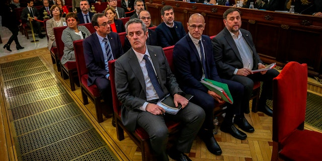 Front row from left, Joaquim Form, Raul Romeva, Oriol Junquera, second row from left, Josep Rull, Jordi Turull, Jordi Sanchez, third row from left, Dolors Bassa, Carmen Forcadell, Jordi Cuixart, back row from left, Meritxell Borras, Santiago Vila, and Carles Mundo during the trial at the Spanish Supreme Court in Madrid, Tuesday, Feb. 12.