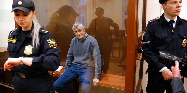 Founder of the Baring Vostok investment fund Michael Calvey sits in a cage in the courtroom in Moscow, Russia, Friday, Feb. 15, 2019.