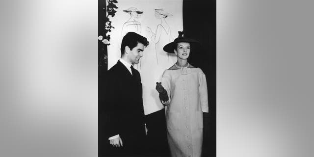 In this Nov. 30, 1953 photo, Karl Lagerfeld poses with an unidentified model in Germany, city not known. (Werner Baum/dpa via AP, file)