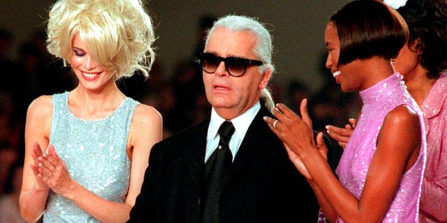 Karl Lagerfeld is applauded by Claudia Schiffer, left, and Naomi Campbell at the end of the Chanel 1997 Spring-Summer ready-to-wear collection presented in Paris.