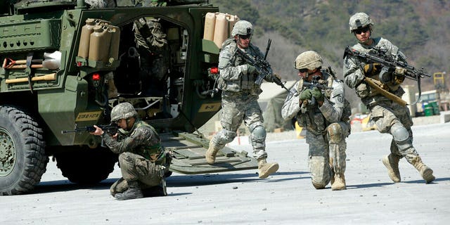 U.S. Army soldiers from the 25th Infantry Division's 2nd Stryker Brigade Combat Team and South Korean soldiers take their position during a demonstration of the combined arms live-fire exercise.