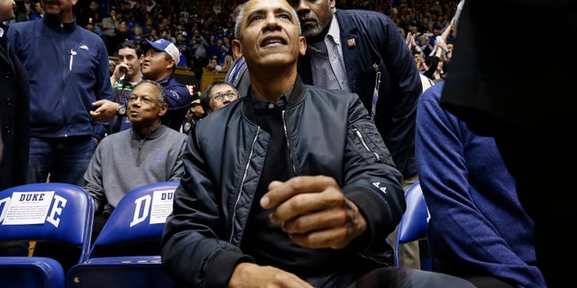 Former President Barack Obama joins fans during an NCAA college basketball game between Duke and North Carolina in Durham, N.C., Wednesday, Feb. 20, 2019. (AP Photo/Gerry Broome)