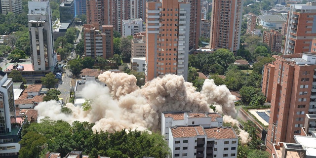 Clouds of dust rise during the implosion of a six-floor apartment building that former cartel boss Pablo Escobar once called home, in Medellin, Colombia, Friday, Feb. 22, 2019. Mayor Federico Gutierrez had been pushing to raze the building and erect in its place a park honoring the thousands of victims, including four presidential candidates and some 500 police officers, killed by Escobar's army of assassins during the Medellin cartel's heyday in the 1980s and 1990s. (AP Photo/Luis Benavidez)