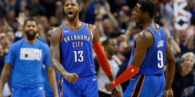 Oklahoma City Thunder forwards Paul George (13) and Jerami Grant (9) celebrate after George hit a shot with less than a second left in the second overtime of an NBA basketball game against the Utah Jazz in Oklahoma City, Friday, Feb. 22, 2019. The Thunder won 148-147.