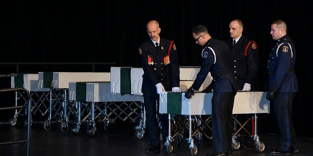 Members of the Halifax Fire and Police honor guard prepare to transport the caskets of the seven Barho children during the funeral for the Syrian refugees in Halifax, Nova Scotia, Canada, on Saturday, Feb. 23, 2019. (Darren Calabrese/The Canadian Press via AP)