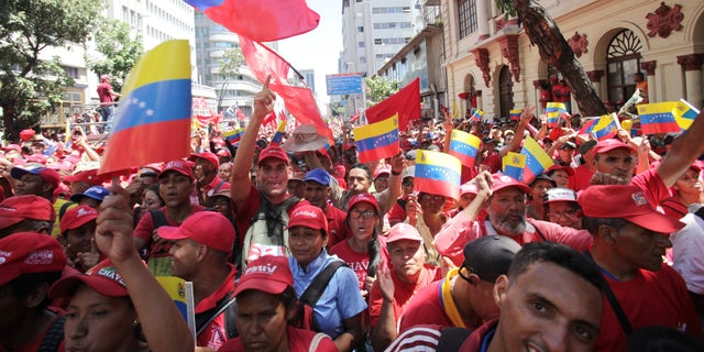 Supporters of President Nicolas Maduro cheer during a pro-government rally in Caracas, Venezuela, Saturday, Feb. 23, 2019. Maduro has closed Venezuela's borders and calls humanitarian aid destained for Venezuela part of a U.S.-led coup. (Associated Press)