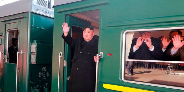 North Korean leader Kim Jong Un waving from a train Saturday before leaving Pyongyang Station, North Korea, for Vietnam. (Korean Central News Agency/Korea News Service via AP)