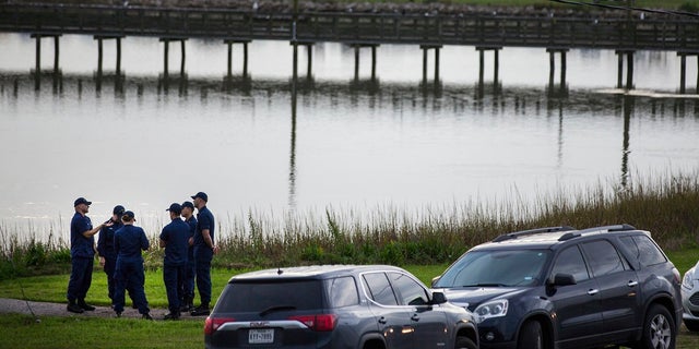 Local and federal officials gather at a staging area during the investigation of a plane crash in Trinity Bay in Anahuac, Texas, Saturday, Feb. 23, 2019. (Brett Coomer/Houston Chronicle via AP)