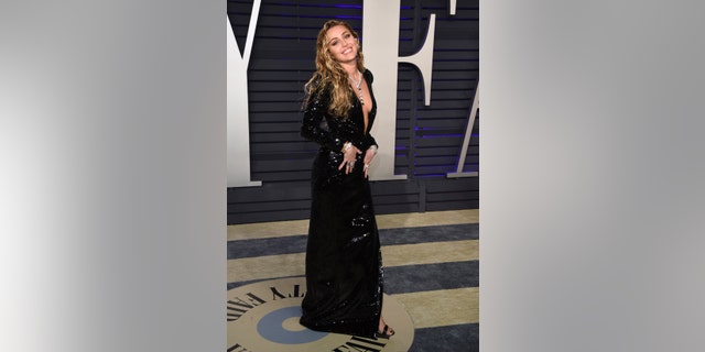 Miley Cyrus arrives at the Vanity Fair Oscar Party.