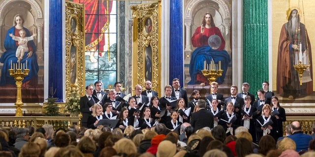 FILE 2018: Concert Choir performs at the St. Isaac's Cathedral in St. Petersburg, Russia. A choir in the Russian city of St. Petersburg has drawn criticism for performing a satirical song about firing a missile on the United States from a Soviet nuclear submarine. (Roman Pimenov, Interpress photo agency via AP)