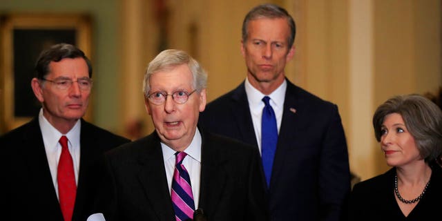 Senate Majority Leader Mitch McConnell, R-Ky., with, from left, Sens. John Barrasso, R-Wyo., McConnell, John Thune, R-S.D., and Joni Ernst, R-Iowa, speakING to reporters on Capitol Hill in Washington, Tuesday. (AP Photo/Manuel Balce Ceneta)