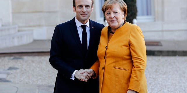 French President Emmanuel Macron, left, greets German Chancellor Angela Merkel prior to their meeting at the Elysee Palace in Paris, Wednesday, Feb. 27.