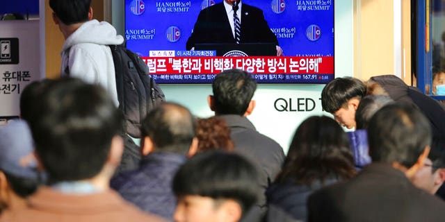 People watch a TV screen showing U.S. President Donald Trump's press conference, during a news program at the Seoul Railway Station in Seoul, South Korea, Thursday, Feb. 28, 2019. The nuclear summit between President Donald Trump and North Korea's Kim Jong Un collapsed Thursday after the two sides failed to reach a deal due to a standoff over U.S. sanctions on the reclusive nation, a stunning end to high-stakes meetings meant to disarm a global threat. The signs read: " Trump talks with North Korea about denuclearization." (AP Photo/Ahn Young-joon)