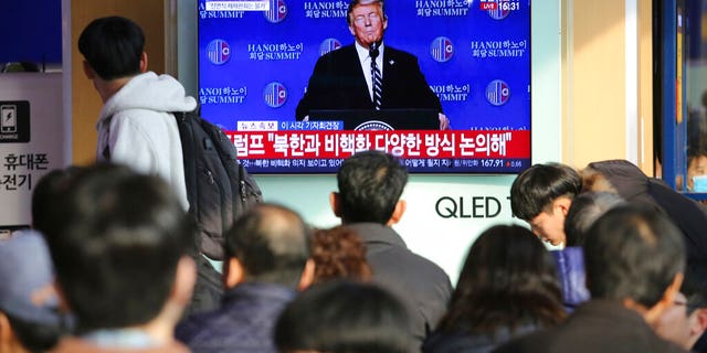 People watch a TV screen showing U.S. President Donald Trump's press conference, during a news program at the Seoul Railway Station in Seoul, South Korea, Thursday, Feb. 28, 2019. The nuclear summit between President Donald Trump and North Korea's Kim Jong Un collapsed Thursday after the two sides failed to reach a deal due to a standoff over U.S. sanctions on the reclusive nation, a stunning end to high-stakes meetings meant to disarm a global threat. The signs read: " Trump talks with North Korea about denuclearization." (AP Photo/Ahn Young-joon)