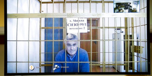 Michael Calvey is seen on a screen during a court session in a courtroom in Moscow, Russia, Thursday, Feb. 28. A Moscow court on Thursday, rejected an appeal by one of Russia's best-known foreign investment managers, ordering to keep Calvey in jail for at least the next month and a half.