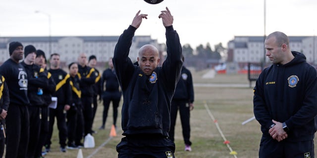 In this Jan. 8, 2019, photo, U.S Army troops watch as instructors demonstrate aspects of the new Army combat fitness test at the 108th Air Defense Artillery Brigade compound at Fort Bragg, N.C.